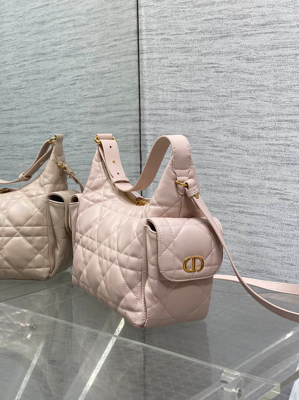 Light pink quilted hobo bag with gold logo ring clasp and top handles