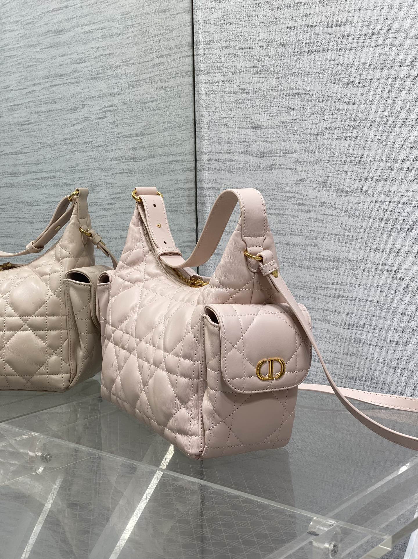 Light pink quilted hobo bag with gold logo ring clasp and top handles