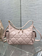 Light pink quilted shoulder bag with curved handle and crossbody strap
