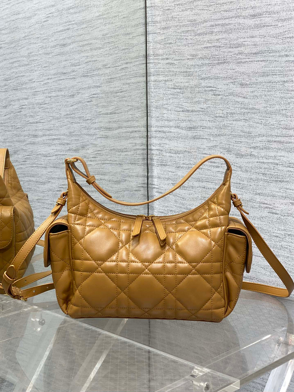 Dior quilted leather handbag with arched top handle and adjustable crossbody strap