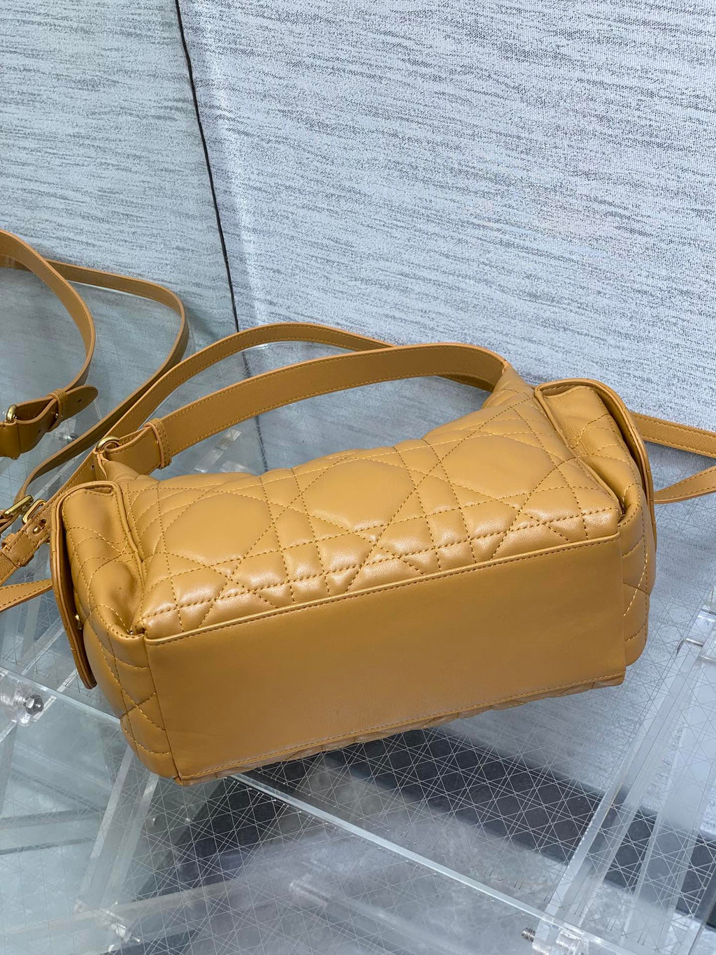 Dior quilted leather shoulder bag with curved top and long crossbody strap