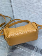Dior quilted leather shoulder bag with curved top and long crossbody strap
