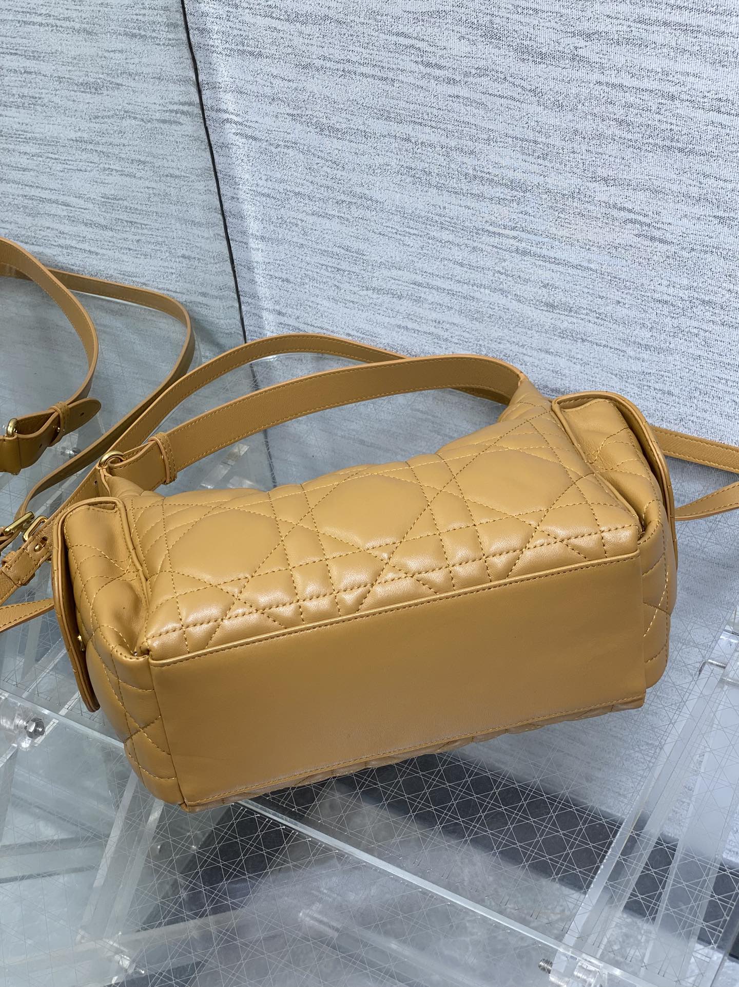 Dior quilted leather shoulder bag with curved top and long crossbody strap