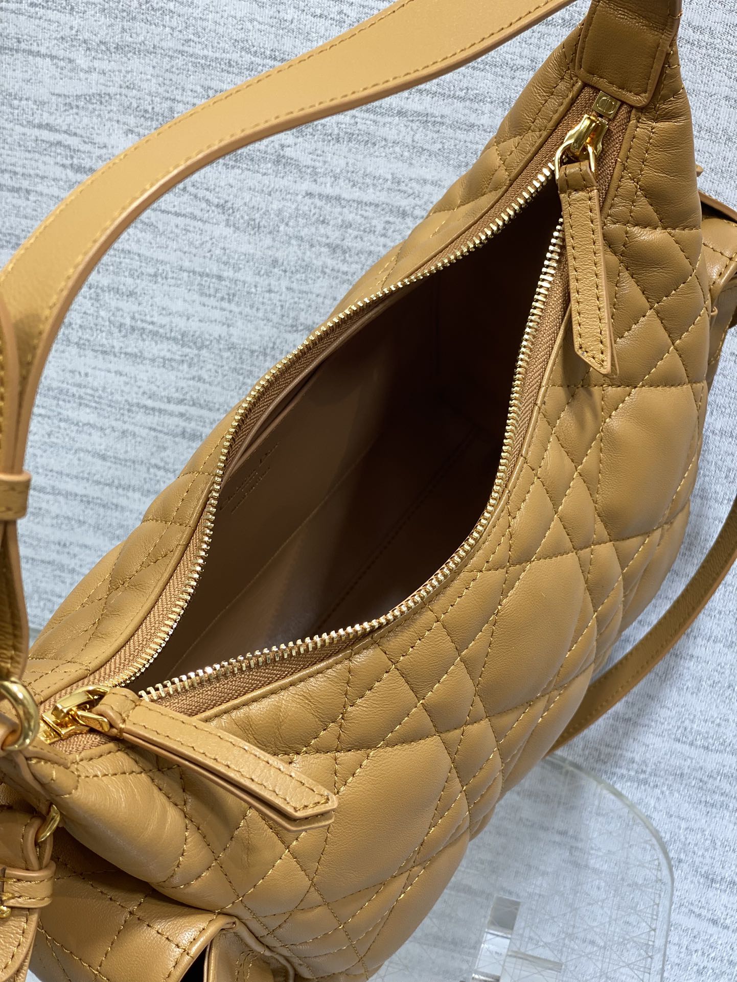 Dior quilted leather bag open view with zipper closure and interior lining