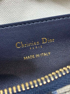 Dior leather label with “Christian Dior” and “Made in Italy” text near gold zipper