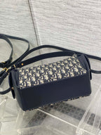 Dior shoulder bag side view with Dior Oblique canvas panel and navy leather trim