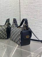 Dior Oblique handbags with navy leather accents, featuring gold CD logo on one bag