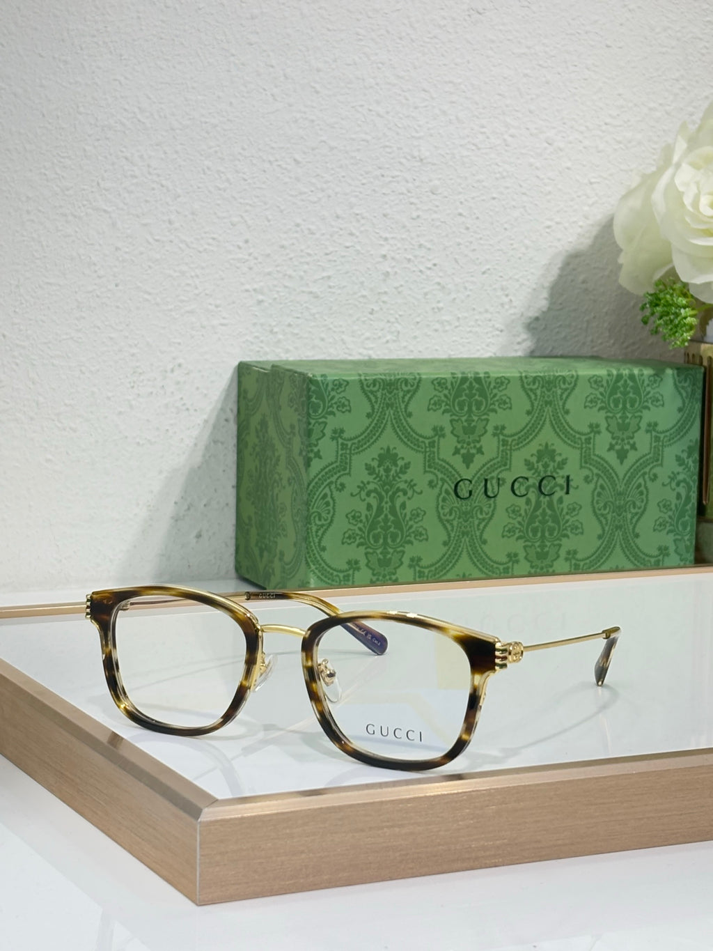 Glasses with tortoiseshell frames, gold accents, and clear lenses