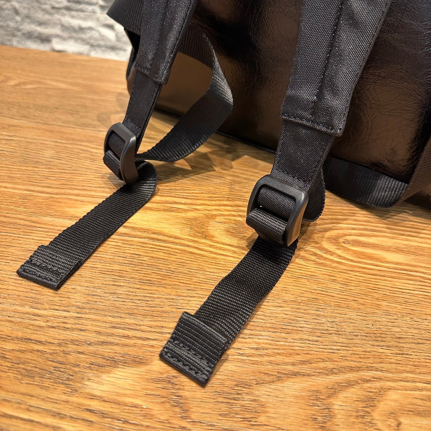 Black fabric shoulder straps with plastic adjustment buckles