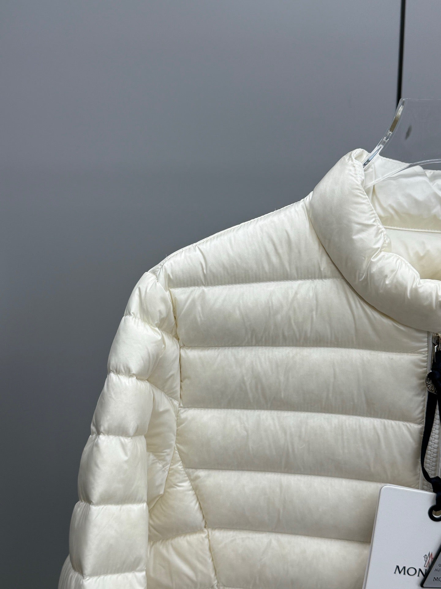 Moncler light quilted puffer sleeve and shoulder with front snap buttons near collar