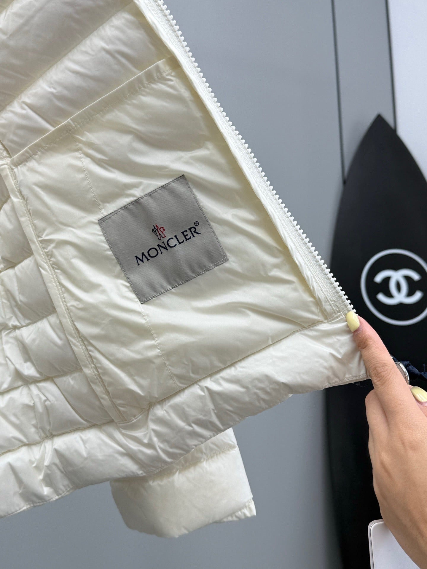 Moncler light puffer jacket inner logo label on pocket, zipper edge visible