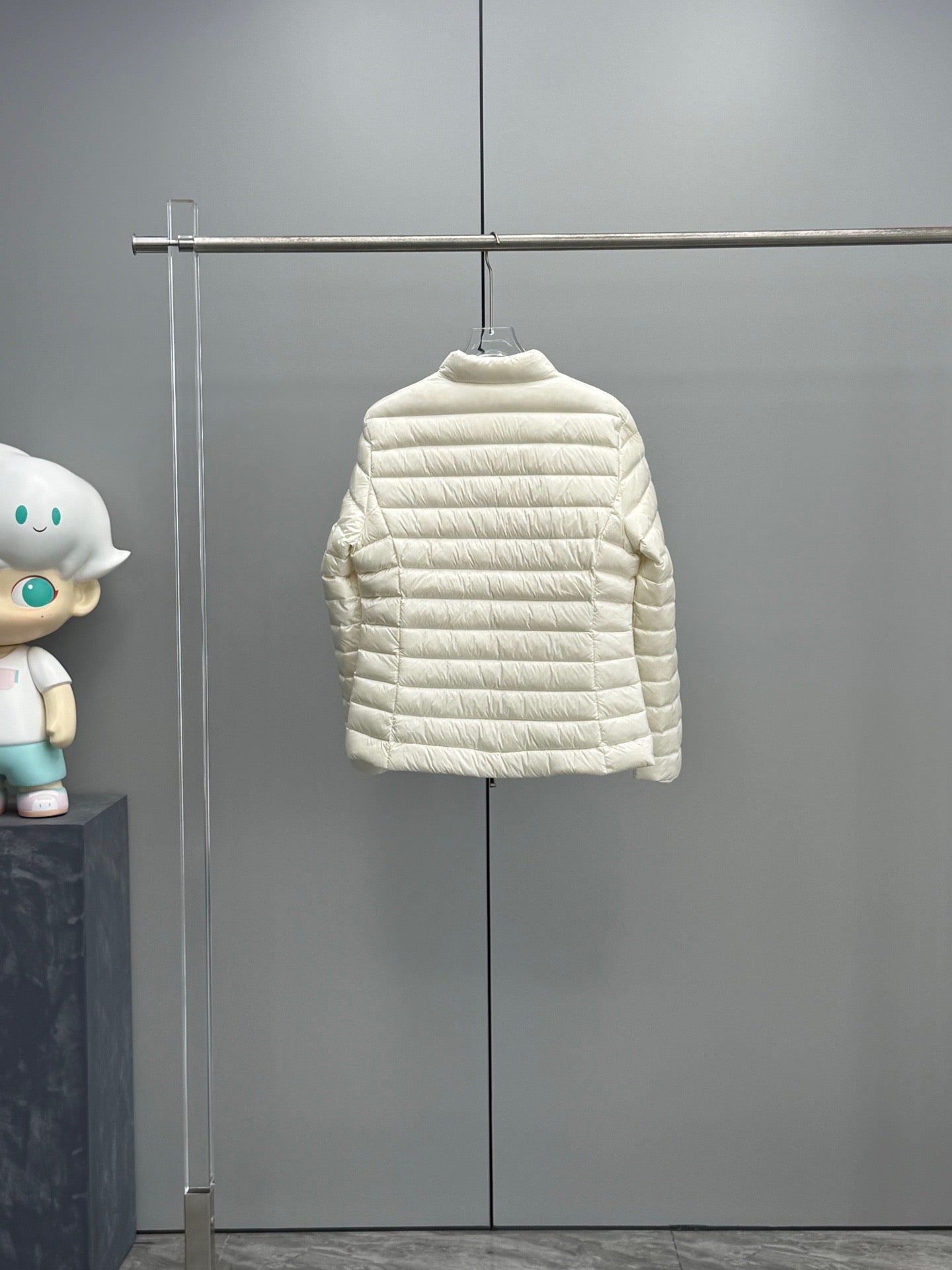 Moncler light hooded puffer jacket on a hanger, quilted horizontal baffles design