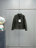 Dark puffer jacket with full zipper and stand collar.
