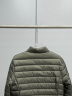 Olive puffer jacket with horizontal quilted stripes and high collar.