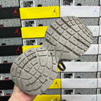 Gray sneaker outsole with deep tread and small grip patterns
