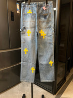 Light blue denim pants with yellow cross embroidery and back pocket patches