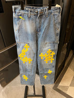Light blue denim pants with yellow cross embroidery and front seam details