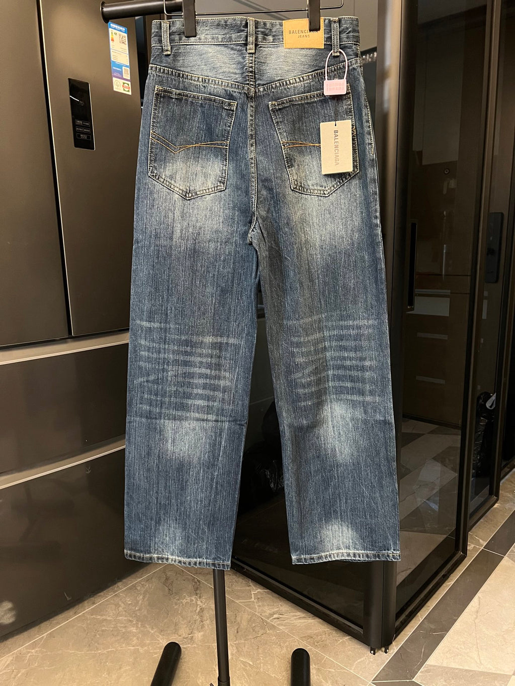 Denim jeans in light blue wash, two front pockets, back patch pockets, button fly