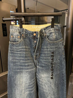 Denim jeans, light blue wash, high-rise waist, belt loops, front button, logo print