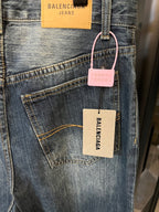 Denim jeans with front pockets, light blue wash, hanging tags on waistband
