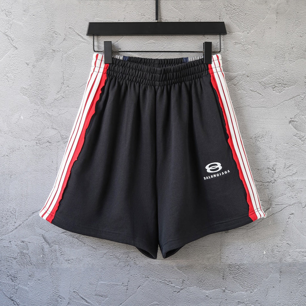 Black Balenciaga track shorts with red and white side stripes, elastic waistband