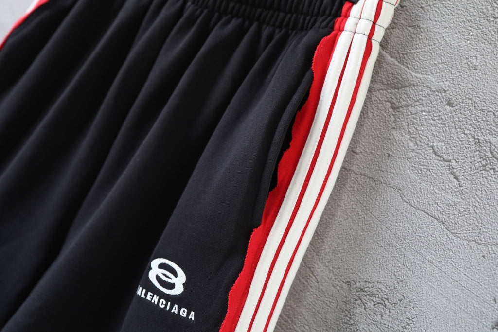Black Balenciaga track shorts fabric with red, white, and blue side stripe trim