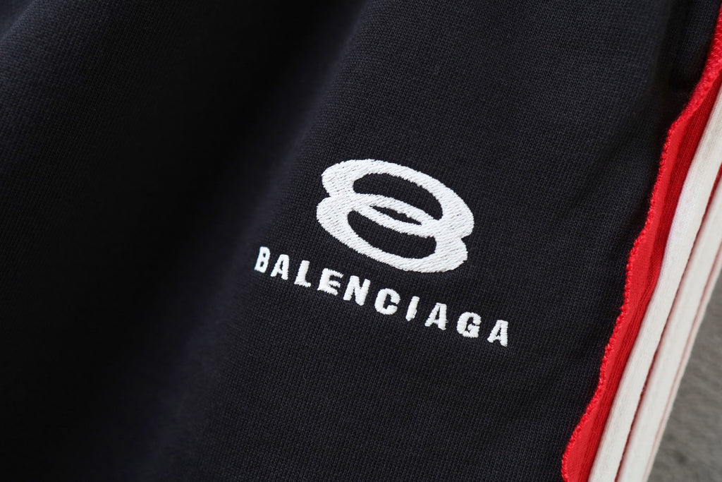 Black Balenciaga track shorts logo patch with red-and-white side stripe