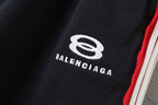 Black Balenciaga track shorts logo patch with red-and-white side stripe