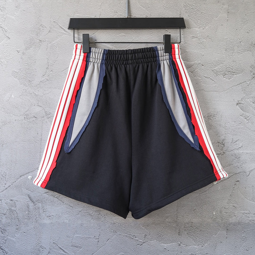 Black Balenciaga track shorts with red/white stripes and blue inner lining panels
