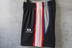 Black Balenciaga track shorts with front logo and vertical red/white/blue stripe panel