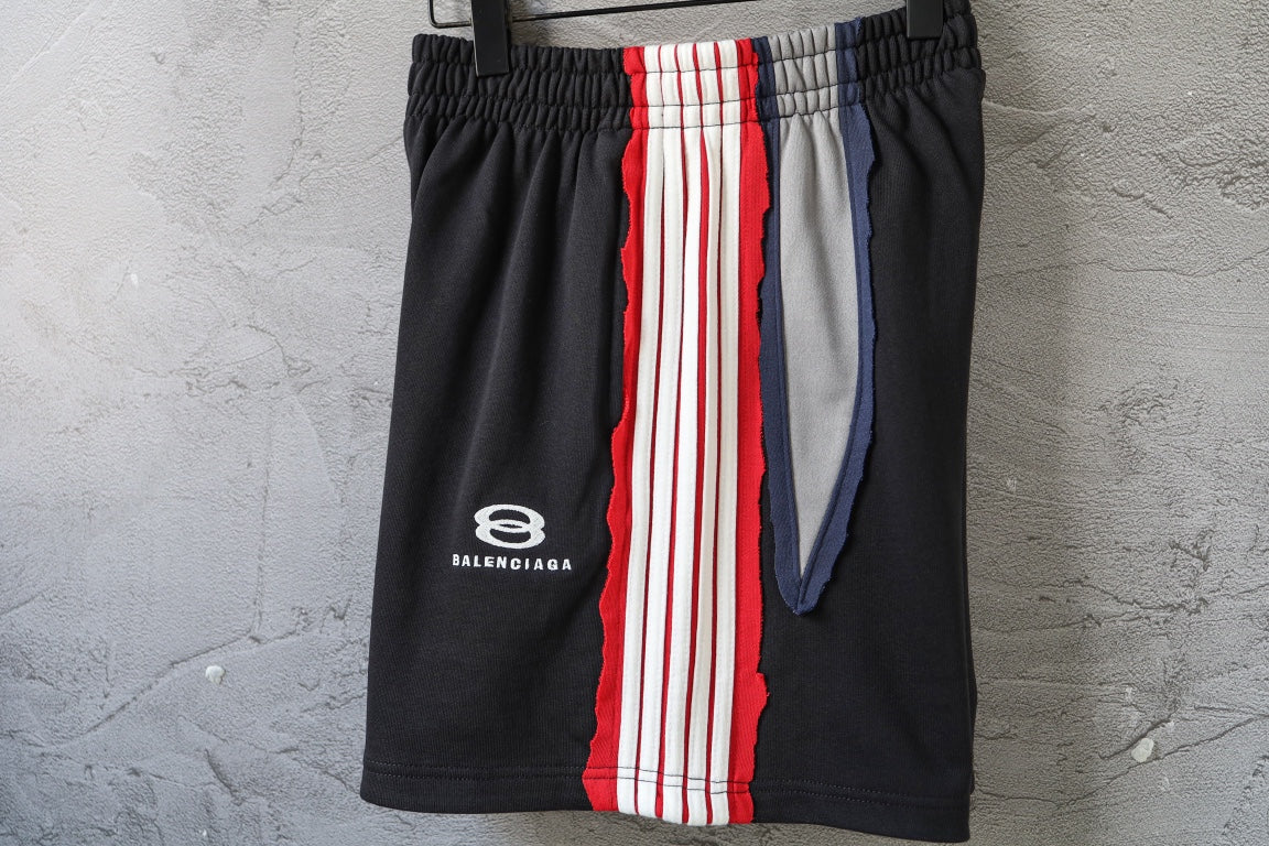 Black Balenciaga track shorts with front logo and vertical red/white/blue stripe panel