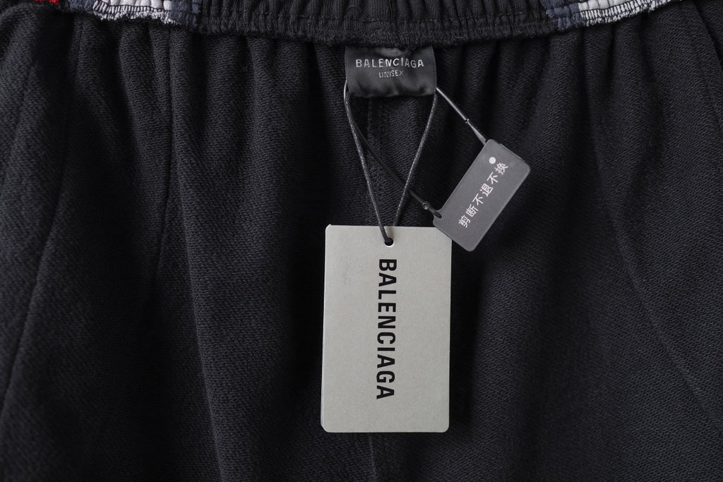 Black Balenciaga track shorts with hang tags at the waistband area