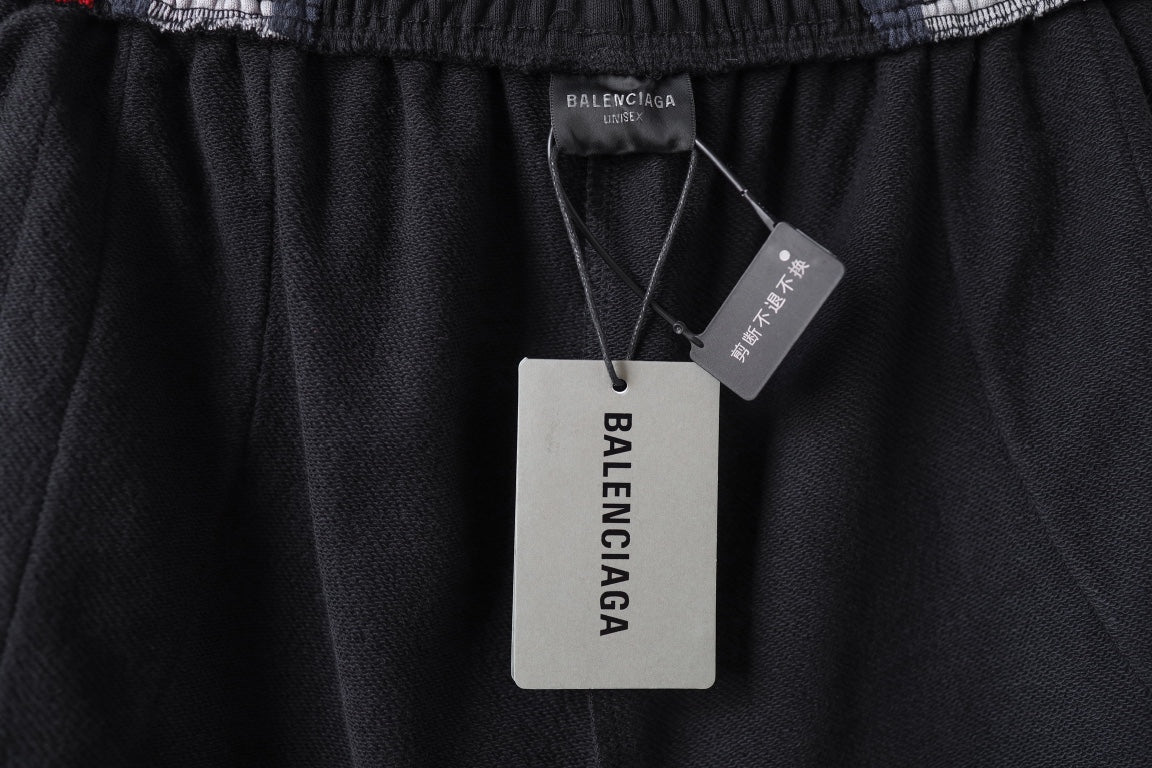 Black Balenciaga track shorts with hang tags at the waistband area