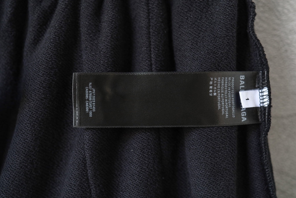 Black Balenciaga track shorts fabric label with size and care information