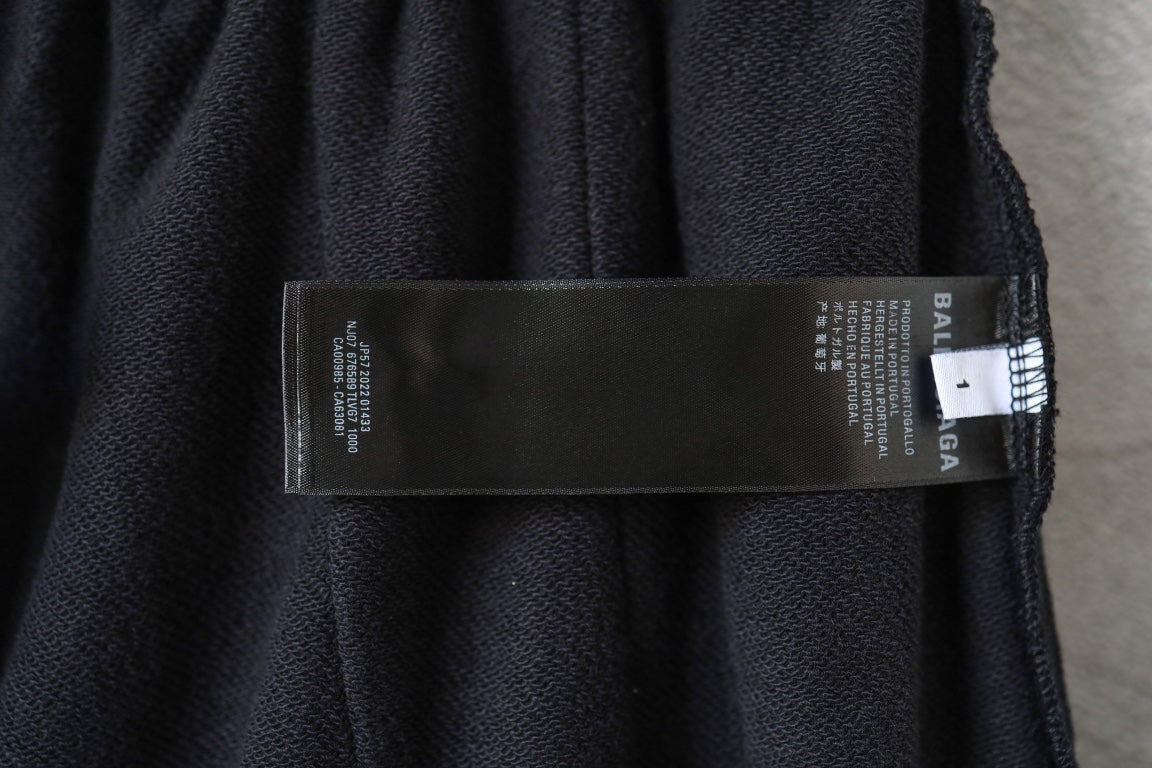 Black Balenciaga track shorts fabric label with size and care information