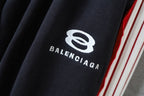 Black fabric with BALENCIAGA logo print and red/white side stripe trim