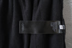 Black track pants with fabric care label and Balenciaga logo on inner waistband