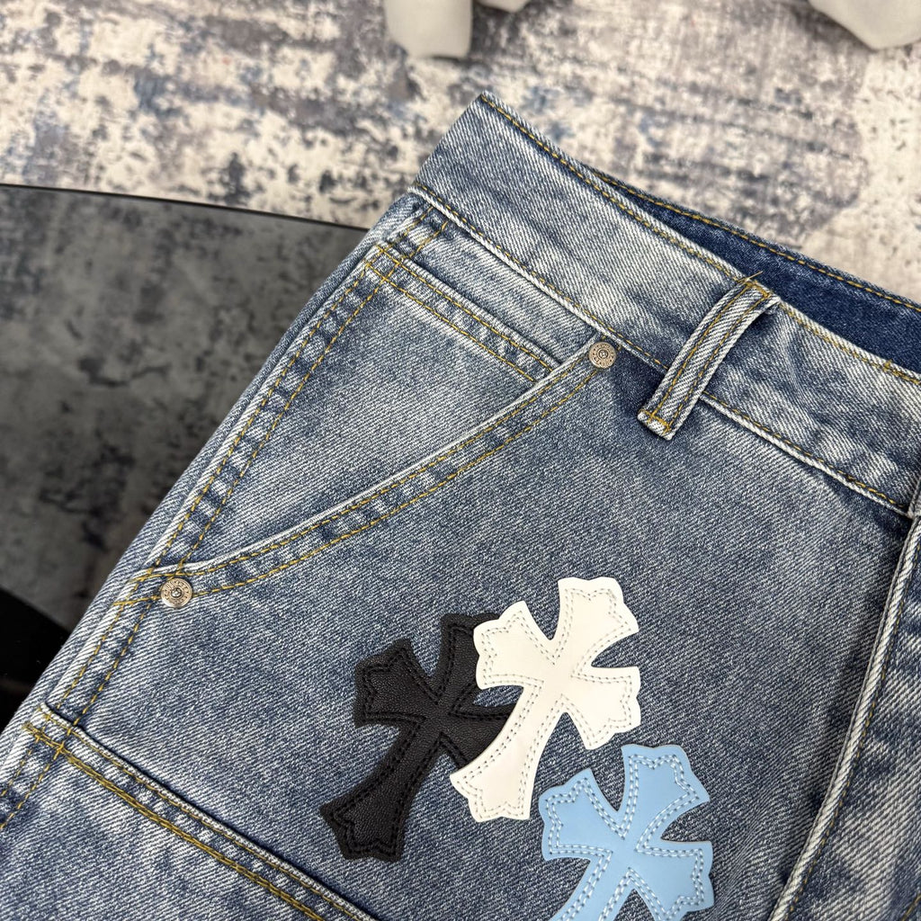 Light blue denim pants with cross applique on front pocket area