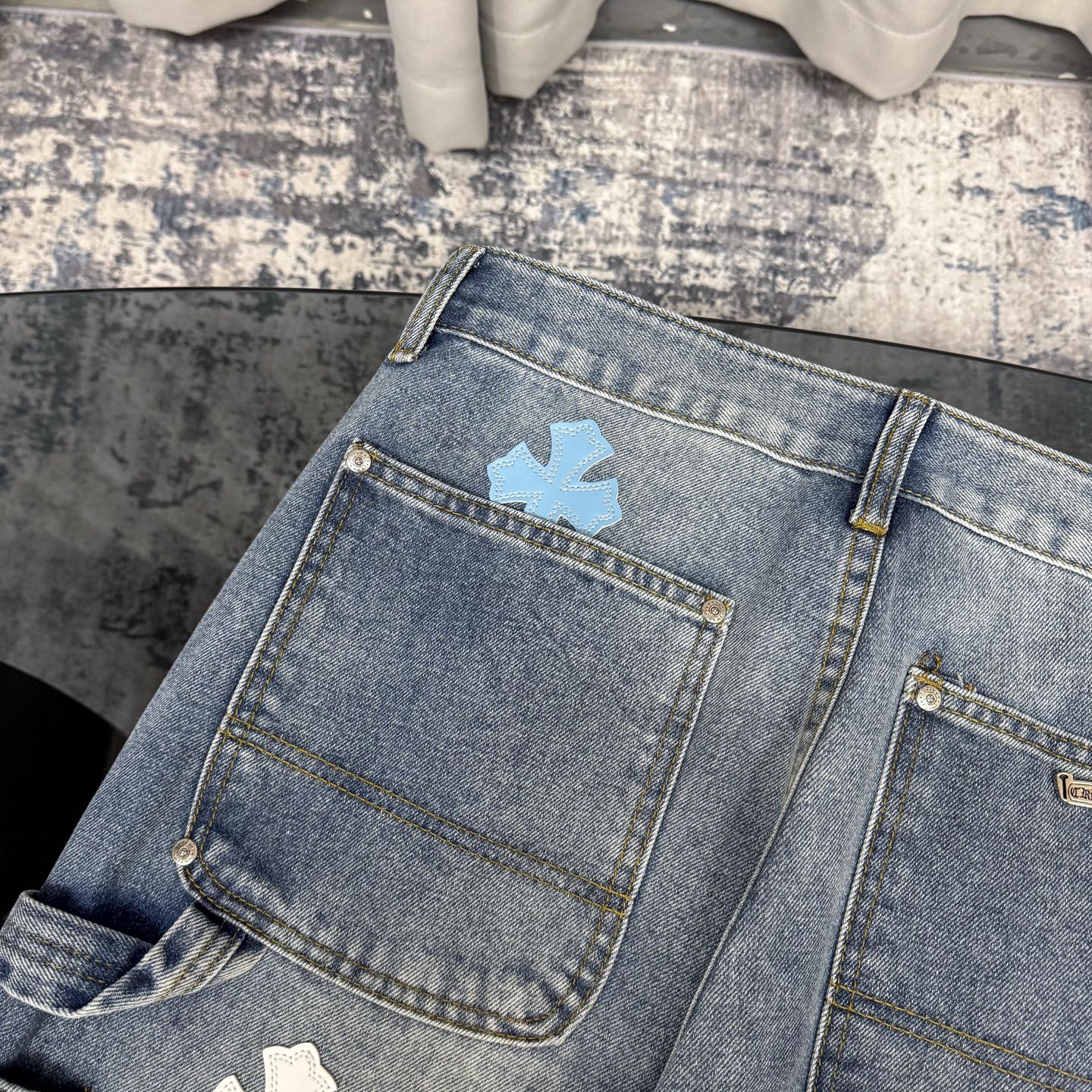 Light blue denim pants with back pockets and visible belt loops