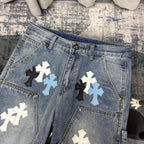 Light blue denim pants with cross applique patches and metal button waistband