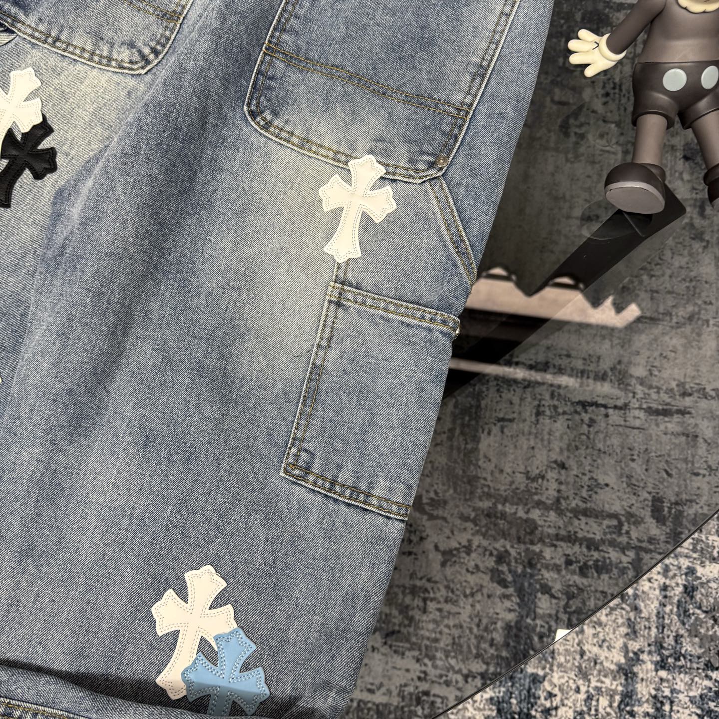 Denim Chrome pants with front patch pocket and cross-shaped applique