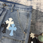 Light blue denim pants with cross applique patches on front and side pockets