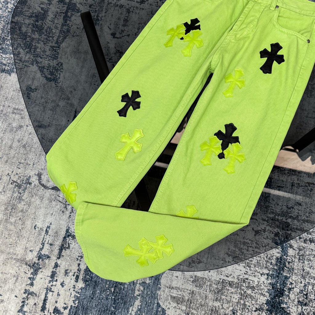Neon lime green pants showing front cross applique print and button closure detail