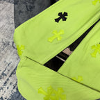 Neon lime green pants with cross appliques on leg, stitched seam detail