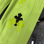 Neon lime green pants with bold black and light green cross patches on leg