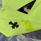 Lime green pants with cross patches on the leg and arched pocket seam details