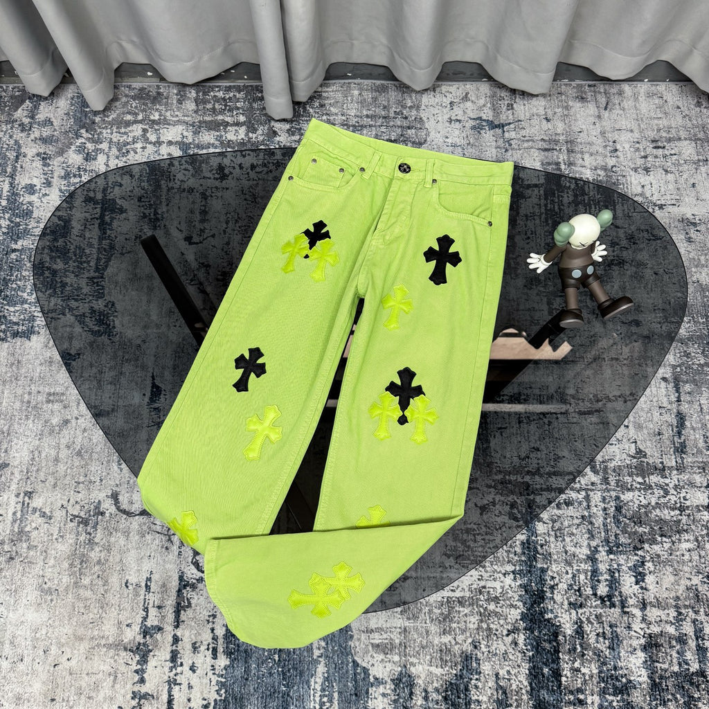 Neon lime green pants with black and green cross patches, button-front and pockets