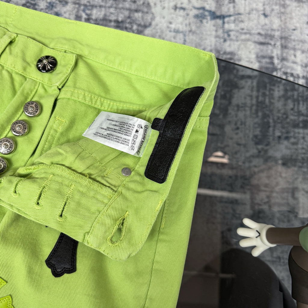 Neon lime green pants with waistband button placket and care label inside pocket