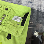 Neon lime green pants with waistband button placket and care label inside pocket