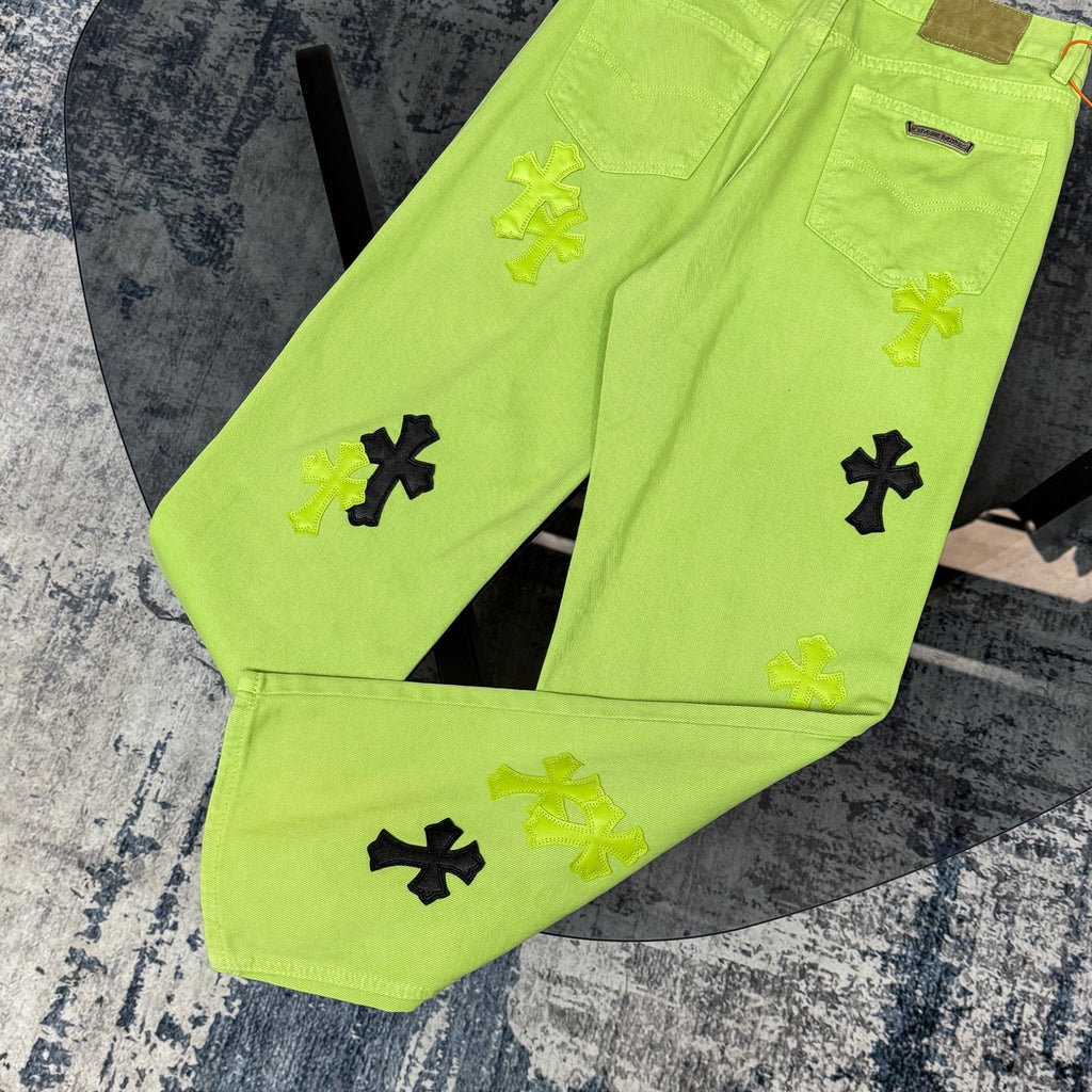 Lime green pants with black and yellow cross appliques across the front legs